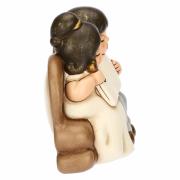 Sposini Thun con libro aperto su divano Bomboniere